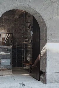 Industrial storefront with metal shelves and glass display cases.