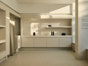A minimalist interior space featuring a display case made of concrete.