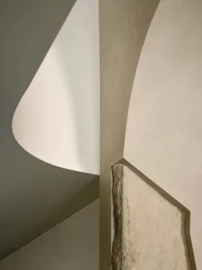 A modern interior space featuring stone and concrete materials.