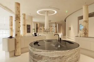 An elegant spa interior featuring modern design elements, marble surfaces, and concrete accents.