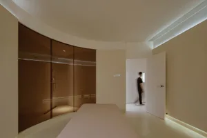 Minimalist bedroom featuring glass and concrete elements