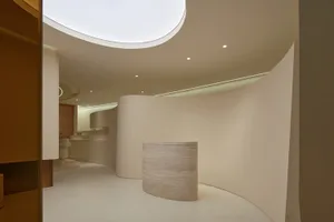 A minimalist reception area featuring curved marble walls designed to impress clients.