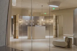 A sleek, modern retail storefront with concrete and marble features.
