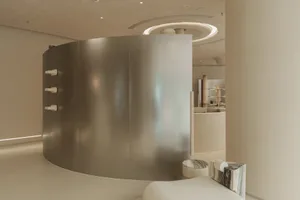 A modern spa room featuring glass walls and marble accents