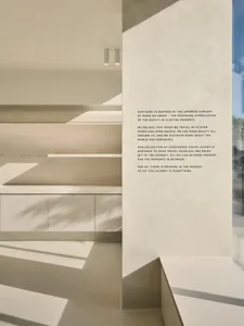 A modern travel goods store featuring minimalist design with concrete and glass materials.