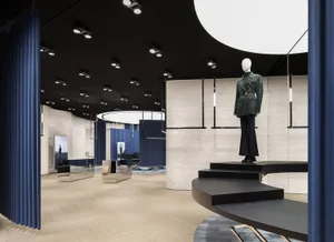A modern fashion retail store with a minimalist black and white interior design.