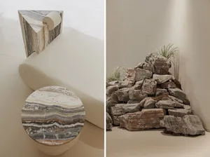 Minimalist interior design featuring a cream-colored ottoman with terrazzo top and side table, surrounded by natural rocks an