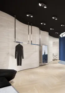 Modern retail store with wooden flooring and curved walls.