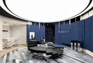 Modern retail storefront with blue acoustic tiles, glass panels, and wooden elements.