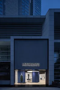 A sleek, minimalist storefront featuring metallic and glass materials.