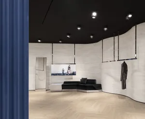 A modern retail storefront featuring metallic and fabric elements on a wooden floor.