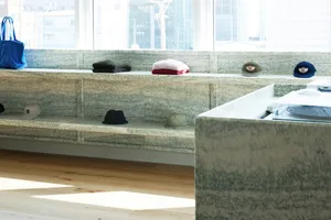Concrete retail space showcasing shelves and hats.