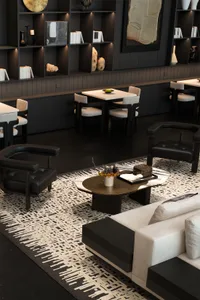 Modern living room with white and black furniture, marble coffee table, and white rug.