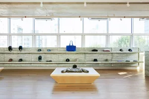 Retail store interior with granite countertop displaying various baseball caps.