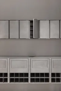 Minimalist storage unit made of metal, featuring an open cabinet and grid-like structure.