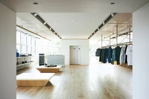 A modern retail space featuring wooden floors and a minimalist design.