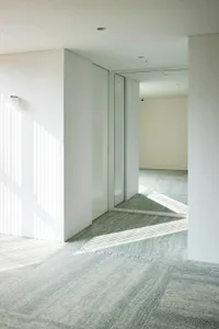 Interior design image showcasing a modern entryway with marble and concrete elements.