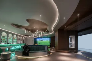 Interior of a modern golf shop featuring concrete walls and neon lighting.