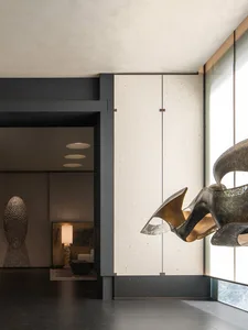 A modern interior design featuring artistic metal art on a wall