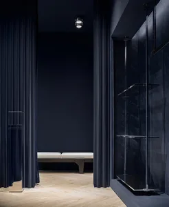 Modern interior design featuring glass, wood, and metal elements.
