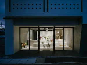 A modern retail storefront with concrete walls and a minimalist design.