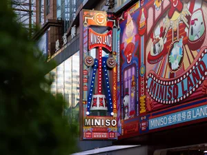 Colorful, bright signage with illustrations and text advertising a Miniso Picker store.