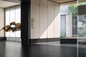 Modern lobby features contemporary art installation on concrete floor and walls