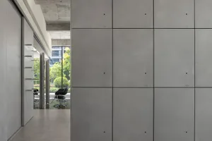 Minimalist living space featuring sleek concrete walls and modern furniture.