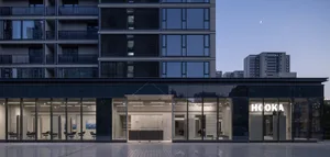 Modern retail shop storefront with large glass windows and concrete details.