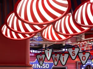 Retail interior featuring red and white striped lighting fixtures.