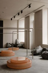 A modern retail space featuring concrete accents and large rocky elements
