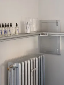 Industrial-style commercial space with metallic radiator and shelving unit.