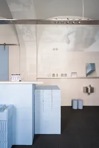 A modern restaurant interior with blue painted walls and minimalist decor.