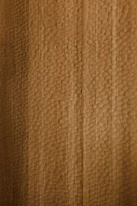 Close-up image of a textured wooden wall surface