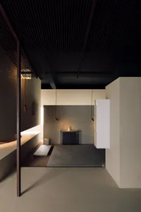 A minimalist living room with concrete flooring and wooden accents.