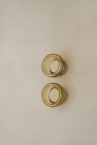 Two modern, amber-colored glass bowls on a neutral background.