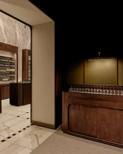 A modern retail space with a marble floor, wooden furniture, and a sleek design.