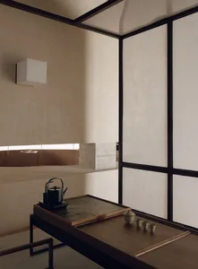 A minimalist modern tea room with wooden elements and a tea setup on a table.