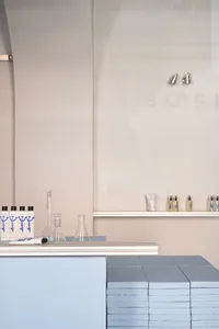 A minimalistic spa office interior with glass elements and clean, modern design.