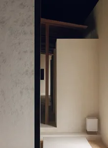 A minimalist interior with concrete and wood materials.