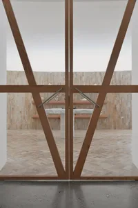 A modern interior with wooden elements, including a table and benches in front of a wall of stone tiles.
