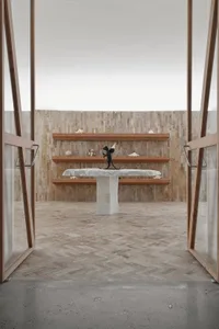 Modern art gallery with wooden shelves and a concrete table