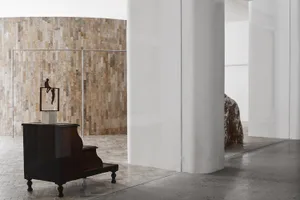 A modern interior featuring wooden furniture against a textured wall.