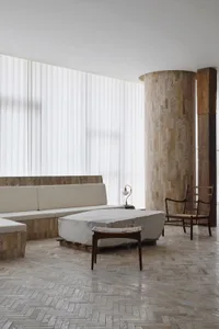 A modern living room featuring a concrete floor and minimalist design.