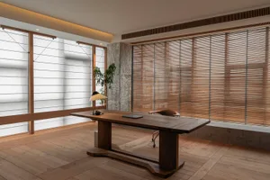 Modern minimalist office space featuring a wooden desk, desk lamp, and wooden floor, with concrete walls and light wooden bli