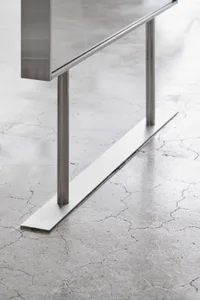 A minimalist design featuring a concrete floor, metal legs, and industrial style.