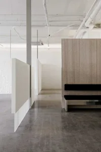 Modern office space with minimalist decor and concrete finishes.