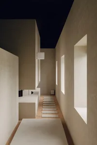 Concrete hallway with minimalist design and lighting fixtures.