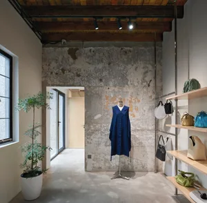Concrete retail storefront with industrial-style design and wooden accents.