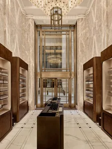 Modern retail storefront featuring marble, wood, and glass materials